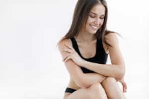 Fashion portrait of a young woman in bikini in studio on white background