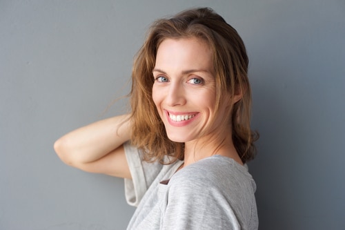 beautiful middle age woman posing with hand in hair